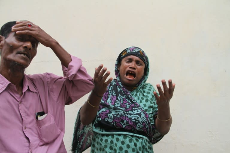 Relatives of Bangladeshi Zakir Hossain Shawon pictured before collecting his body in Dhaka on July 9, 2015