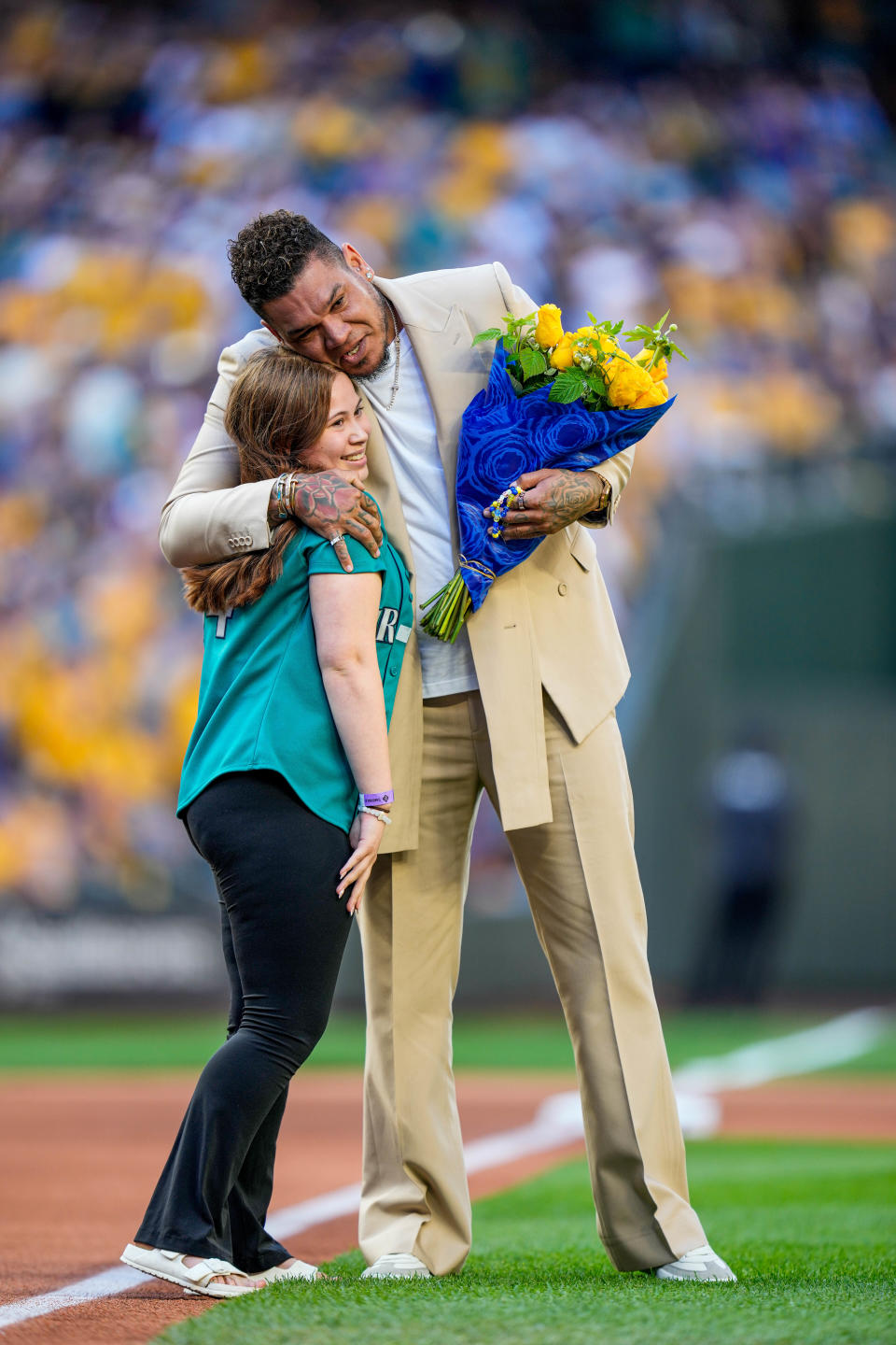 Former Seattle Mariners pitcher Felix Hernandez hugs Sophia Robinson, whom he had met through the Make-A-Wish Foundation when she was younger. She surprised Hernandez during his induction into the Mariners Hall of Fame.