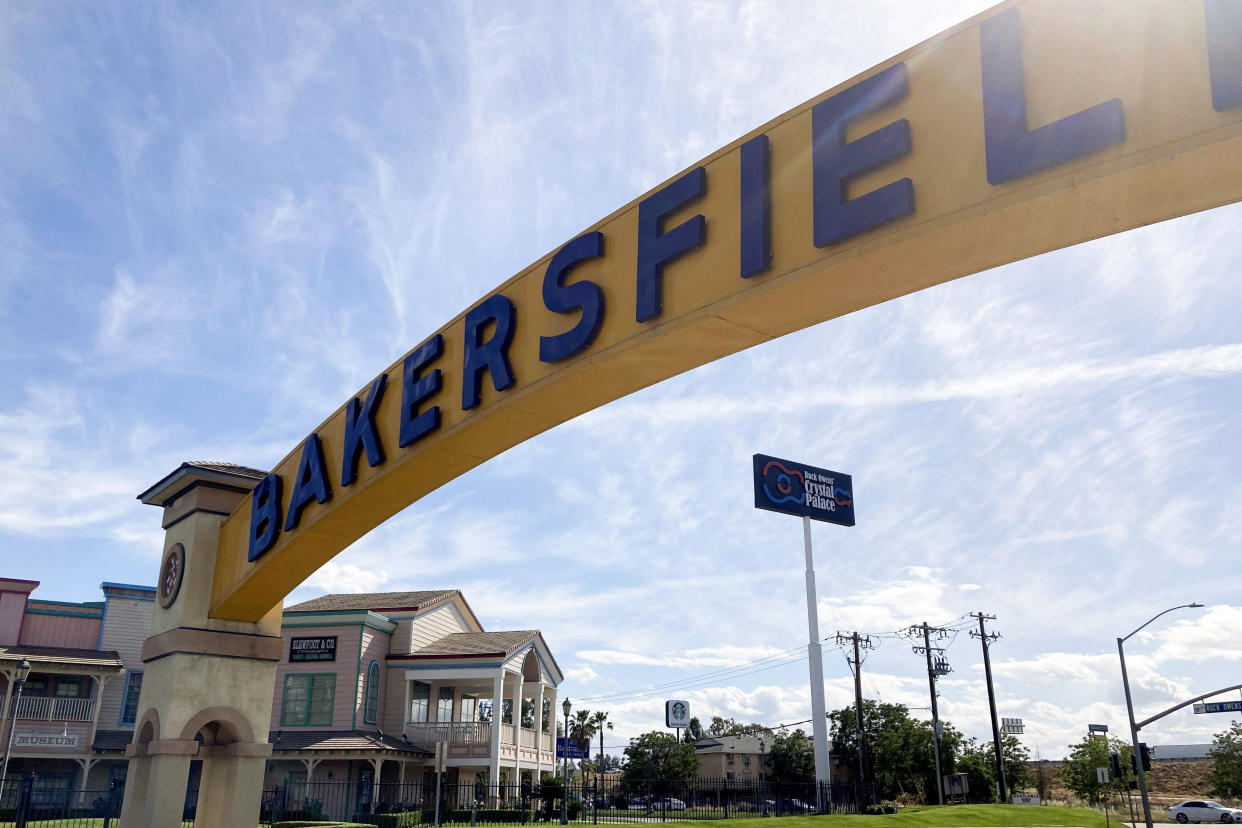 A sign for Bakersfield, Calif., is displayed over Sillect Avenue at Buck Owens Boulevard on April 20, 2022. Kevin McCarthy is a son of California's Central Valley, a farming and oil-pumping heartland. (AP Photo/Lisa Mascaro)