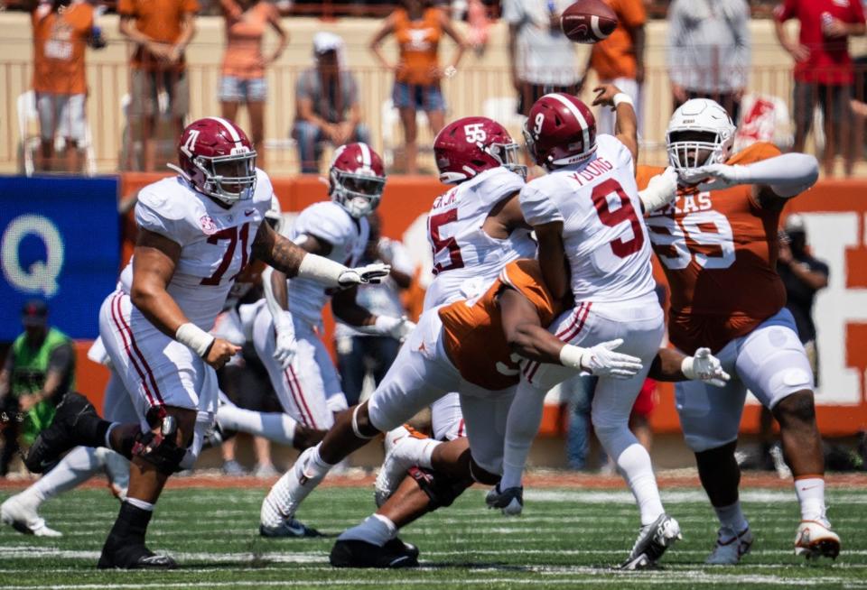 Texas defensive lineman Alfred Collins tackles Alabama quarterback Bryce Young during the second half of last year's Crimson Tide victory in Austin. Alabama is a seven-point favorite heading into Saturday's showdown in Tuscaloosa.
