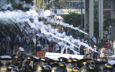 Police fired tear gas during a clash with mobs in the Tanah Abang Market area, Jakarta - Credit: Getty