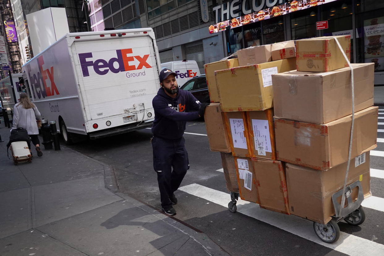 A FedEx worker delivers packages in Manhattan, New York City, U.S., May 9, 2022. REUTERS/Andrew Kelly