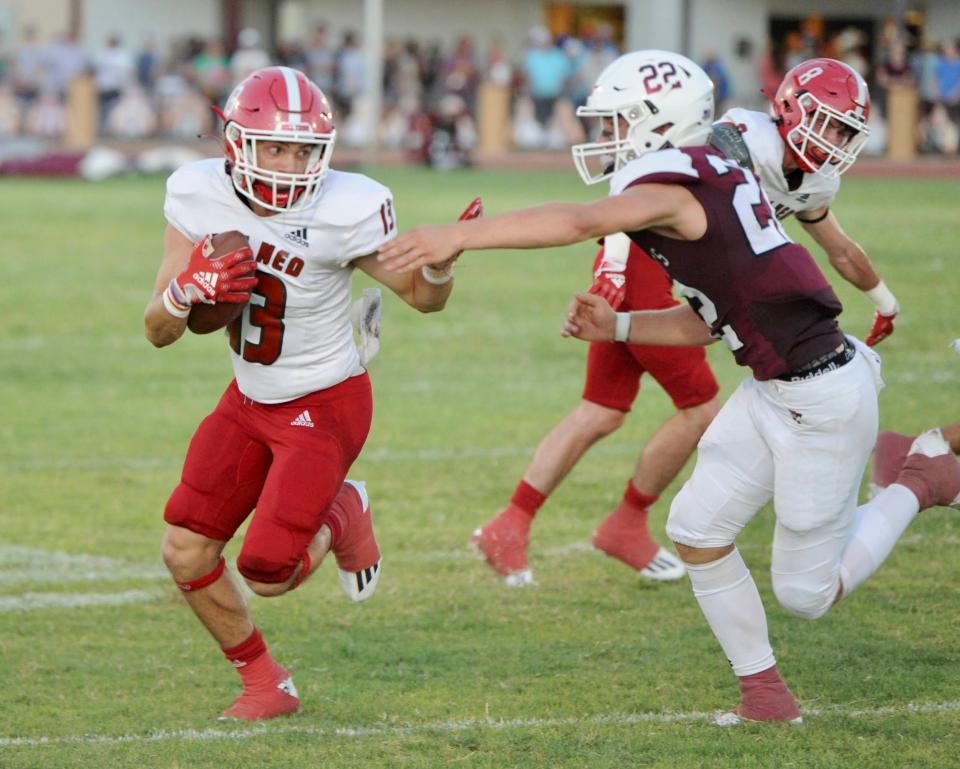 Jim Ned's Jake Rushing tries to break away from Hawley's Will Scott on Aug. 26 in Hawley.