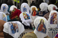 Nuns wear headwear showing the Virgin Mary and Jesus Christ as they await the arrival of Pope Francis for a Holy Mass at the John Garang Mausoleum in Juba, South Sudan Sunday, Feb. 5, 2023. Pope Francis is in South Sudan on the final day of a six-day trip that started in Congo, hoping to bring comfort and encouragement to two countries that have been riven by poverty, conflicts and what he calls a "colonialist mentality" that has exploited Africa for centuries. (AP Photo/Ben Curtis)