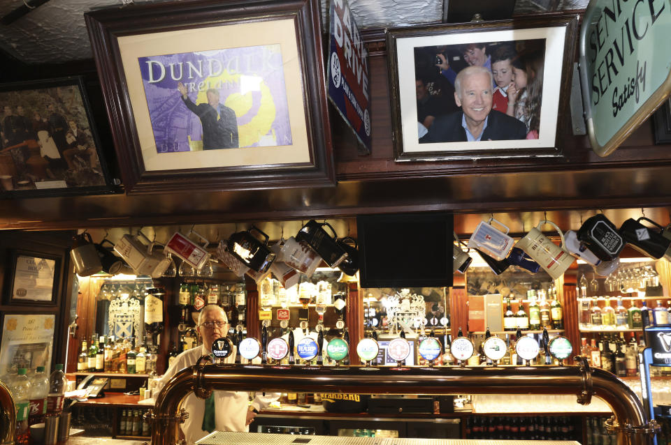 A picture of President Joe Biden, right hangs above the bar next to a picture of former President Bill Clinton, in Fitzpatrick's pub in the village of Carlingford, near Ballina, Ireland, Wednesday, April, 5, 2023. The pub was visited by Biden in 2016. Excitement is building in Ballina, a small Irish town that was home to some of President Joe Biden's ancestors. Biden is scheduled to visit the town next week, part of a four-day trip to Ireland and neighboring Northern Ireland.(AP Photo/Peter Morrison)