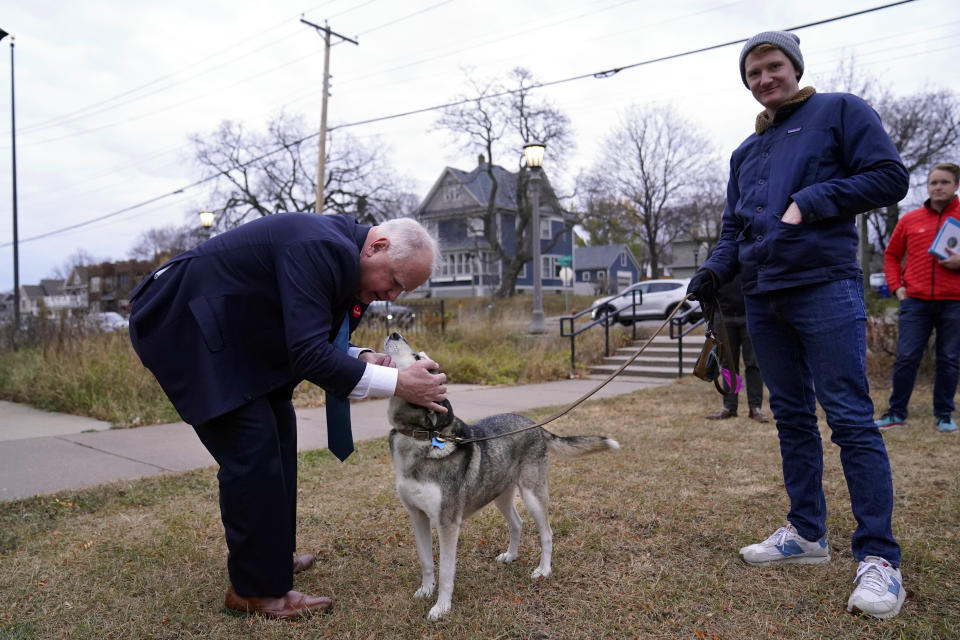 Minnesota Gov. Tim Walz, left, pets a Siberian Husky after voting Tuesday, Nov. 8, 2022, in St. Paul. (AP Photo/Abbie Parr)