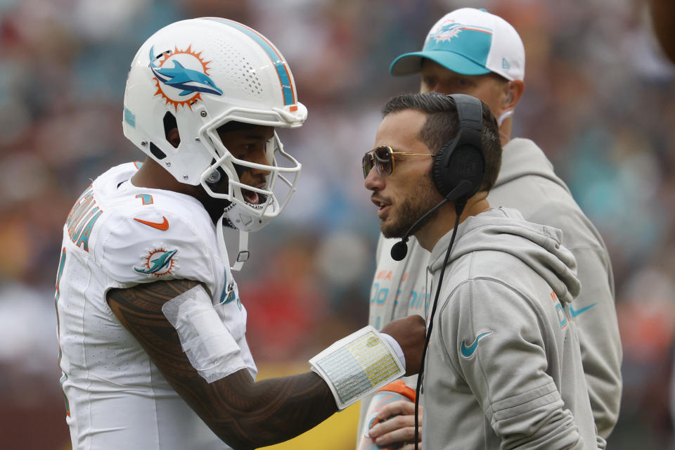 Miami Dolphins quarterback Tua Tagovailoa (1) talks with Dolphins head coach Mike McDaniel (R). Mandatory Credit: Geoff Burke-USA TODAY Sports