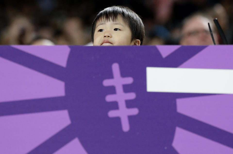 A young fan waits for the start of the Rugby World Cup Pool D game at Sapporo Dome between Australia and Fiji in Sapporo, Japan, Saturday, Sept. 21, 2019. (AP Photo/Aaron Favila)