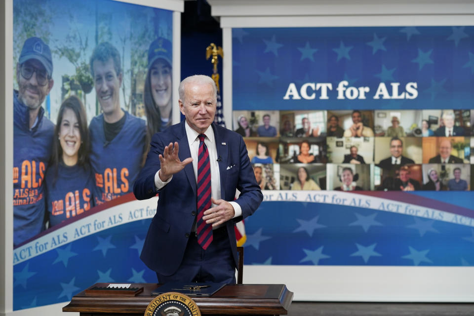 President Joe Biden stands after signing the "Accelerating Access to Critical Therapies for ALS Act" into law during a ceremony in the South Court Auditorium on the White House campus in Washington, Thursday, Dec. 23, 2021. (AP Photo/Patrick Semansky)