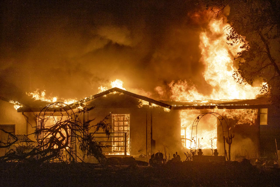 FILE - In this Sept. 27, 2020, file photo, a house burns on Platina Road at the Zogg Fire near Ono, Calif. California's largest utility company said its equipment might have caused a fatal wildfire last month in a county in the northern part of the state, the Mercury News reported Saturday, Oct. 10, 2020. (AP Photo/Ethan Swope, File)