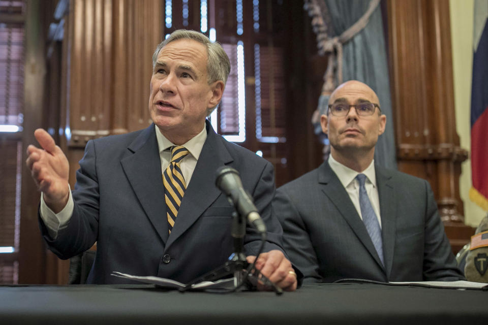 FILE - In this June 21, 2019 file photo, Gov. Greg Abbott, left, speaks at a news conference at the Capitol, in Austin, Texas. Abbott says the state will reject the re-settlement of new refugees, becoming the first state known to do so under a recent Trump administration order. In a letter released Friday, Jan, 10, 2020, Abbott wrote that Texas "has been left by Congress to deal with disproportionate migration issues resulting from a broken federal immigration system." He added that Texas, which typically takes in thousands of refugees each year, has done "more than its share." Governors in 42 other states have said they will consent to allowing in more refugees, according to the Lutheran Immigration and Refugee Service.(Jay Janner/Austin American-Statesman via AP, File)