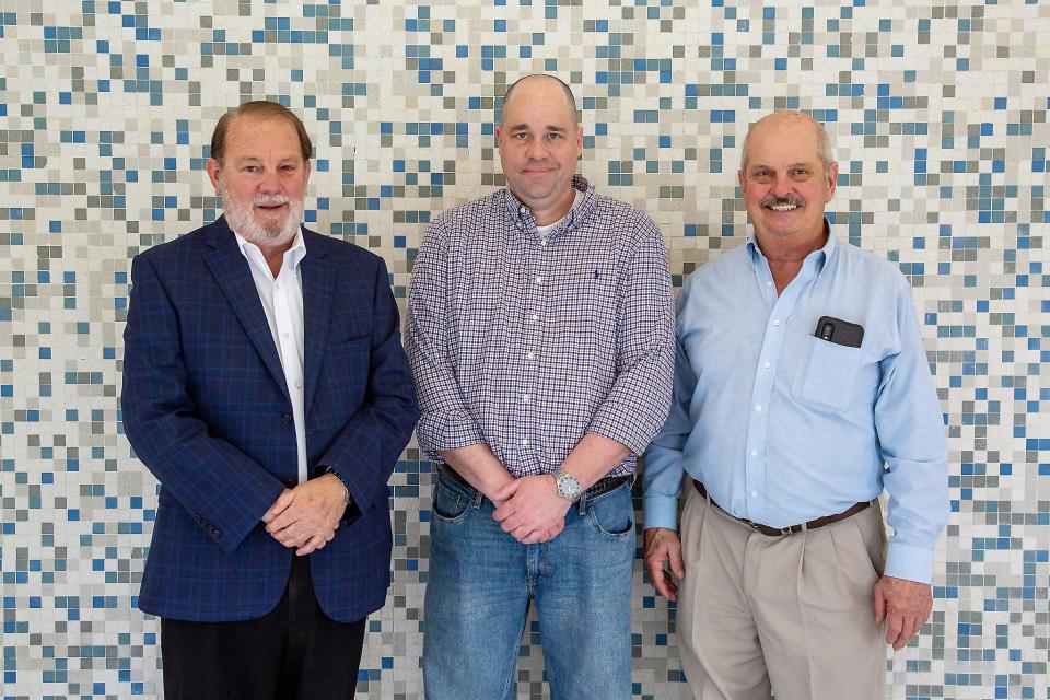 David Hooks, left, is pictured with Eric Boring and Joey Moore of Magneco/Metrel following Tuesday's Gadsden City Council meeting, where the company was given tax incentives to locate on the old Republic/Gulf States Steel property in Alabama City.