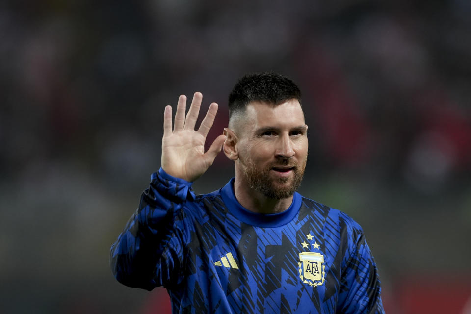 Argentina's Lionel Messi waves to fans ahead of a qualifying soccer match against Peru for the FIFA World Cup 2026 at the National stadium in Lima, Peru, Tuesday, Oct. 17, 2023.(AP Photo/Guadalupe Pardo)