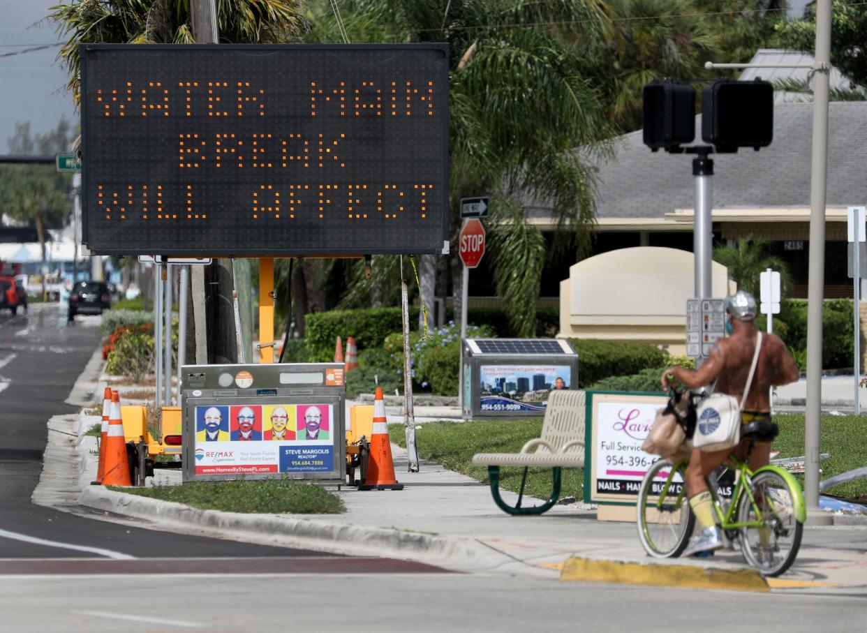 Fort Lauderdale fire and rescue teams work at the scene of a water main break near the Fort Lauderdale Executive Airport on July 18, 2019. Residents in Fort Lauderdale and surrounding cities are being warned they may be without water for at least 24 hours after a contractor hit a water main during construction.