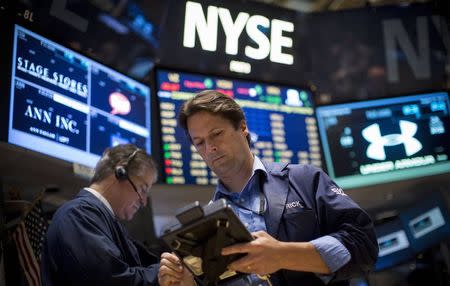 Traders work on the floor of the New York Stock Exchange August 22, 2014. REUTERS/Brendan McDermid