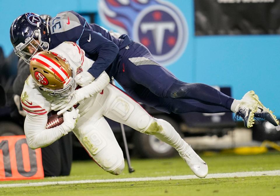 Tennessee Titans safety Amani Hooker (37) tackles San Francisco 49ers wide receiver Deebo Samuel (19) during the fourth quarter at Nissan Stadium Thursday, Dec. 23, 2021 in Nashville, Tenn. 