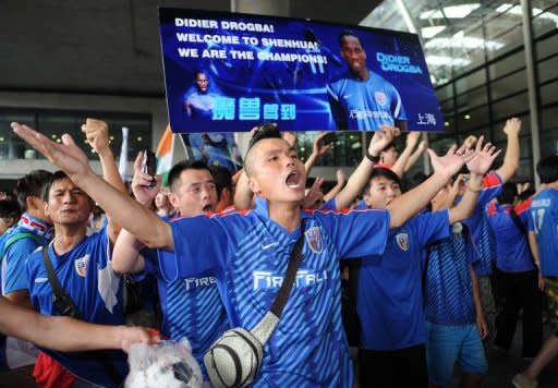 Shanghai Shenhua fans welcome former Chelsea football star Didier Drogba arrived at Pudong international airport in Shanghai on July 14, 2012. Drogba will take up his new role at Shanghai Shenhua FC after announcing last month he had signed with the big-spending Chinese club until 2014, joining his former Chelsea teammate Nicolas Anelka who started with the team in January