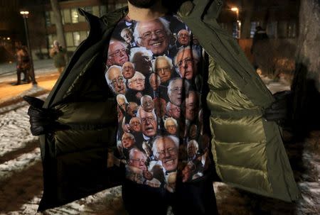 A supporter for U.S. presidential Democratic candidate Bernie Sanders shows his t-shirt before a U.S. Democratic presidential candidates debate in Milwaukee, Wisconsin, United States February 11, 2016. REUTERS/Darren Hauck