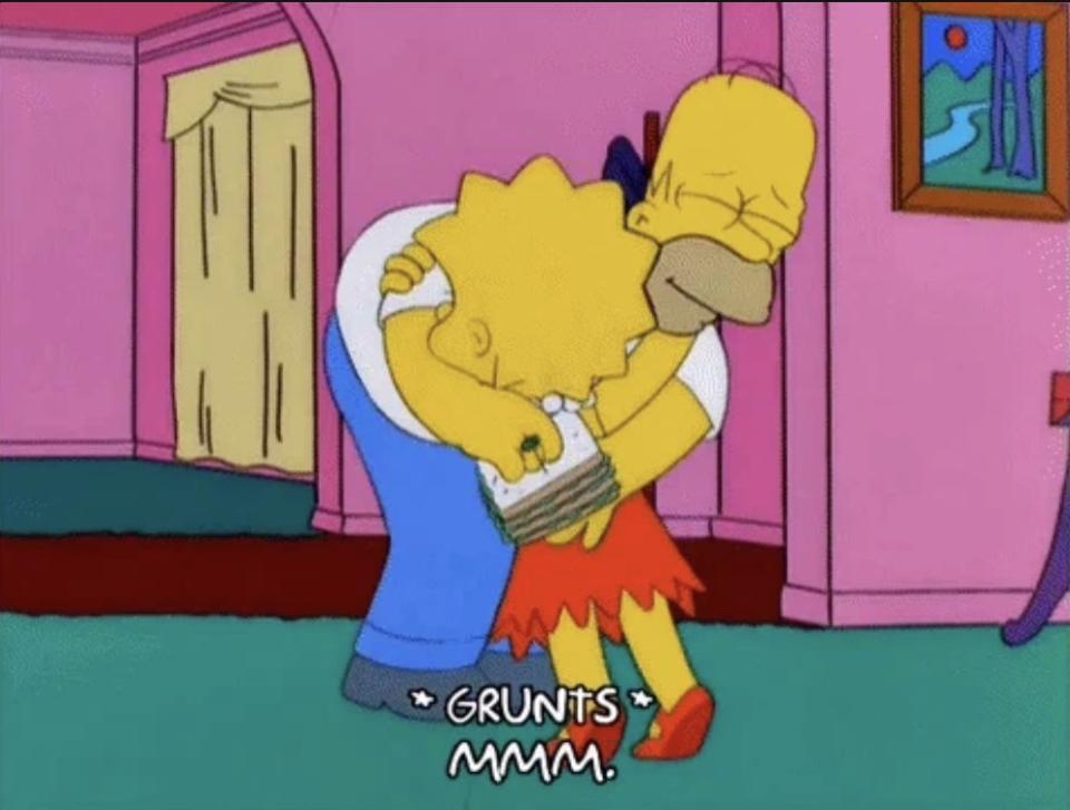 Homer Simpson hugs and grunts with Lisa Simpson in a living room in a scene from 