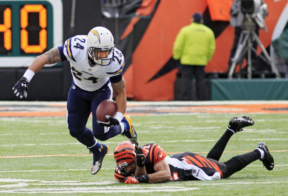 San Diego Chargers running back Ryan Mathews (24) avoids the tackle by Cincinnati Bengals safety Chris Crocker in the first half of an NFL wild-card playoff football game on Sunday, Jan. 5, 2014, in Cincinnati. (AP Photo/Tom Uhlman)