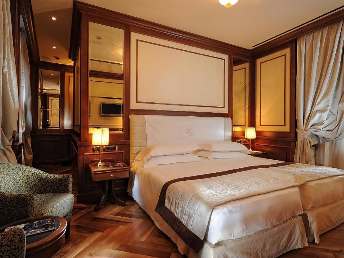 The traditional rooms come with polished wood and honey marble (Booking.com)