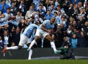 Manchester City's captain Vincent Kompany (R) celebrates after scoring against West Ham United during their English Premier League soccer match at the Etihad Stadium in Manchester, northern England May 11, 2014. REUTERS/Darren Staples