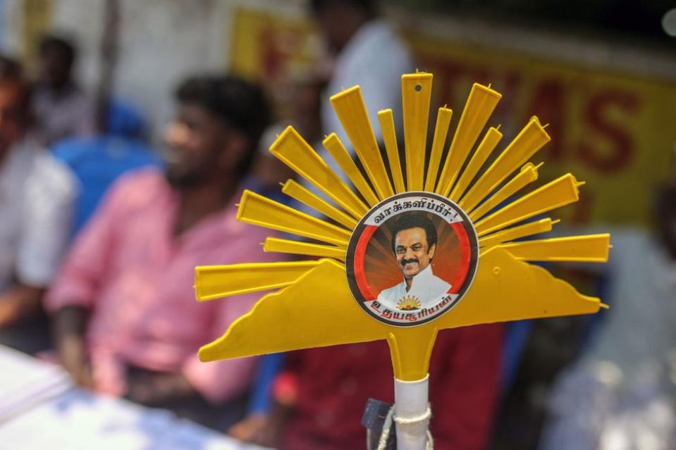 A sign featuring the logo for the Dravida Munnetra Kazhagam (DMK) party near a polling station during the first phase of voting for national elections in Chennai, Tamil Nadu, India, on Friday, April 19, 2024.