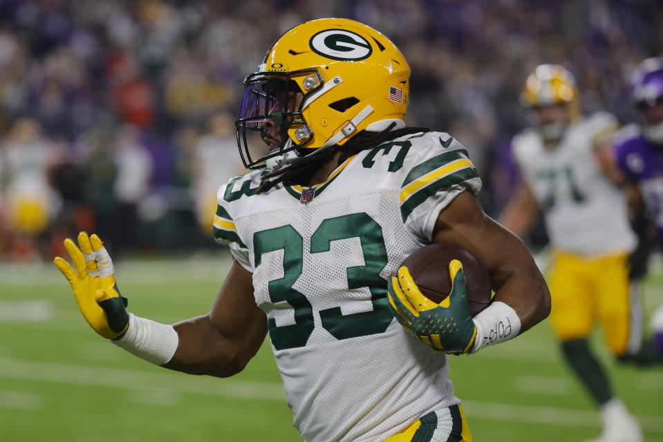 Green Bay Packers' Aaron Jones runs during the first half of an NFL football game against the Minnesota Vikings Sunday, Dec. 31, 2023, in Minneapolis. (AP Photo/Bruce Kluckhohn)