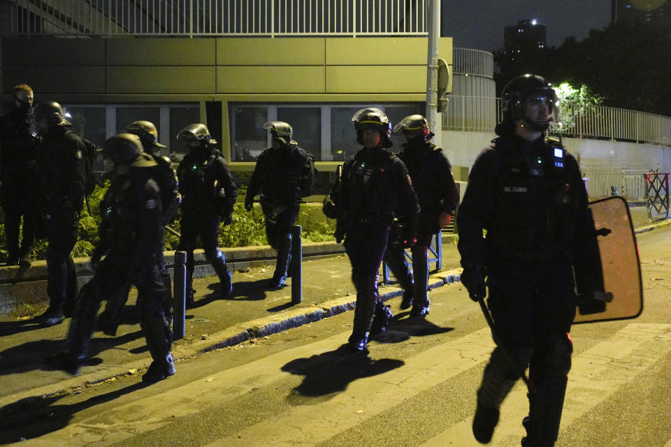 Police officers patrol in Nanterre, outside Paris, France, Saturday, July 1, 2023. French President Emmanuel Macron urged parents Friday to keep teenagers at home and proposed restrictions on social media to quell rioting spreading across France over the fatal police shooting of a 17-year-old driver. (AP Photo/Lewis Joly)