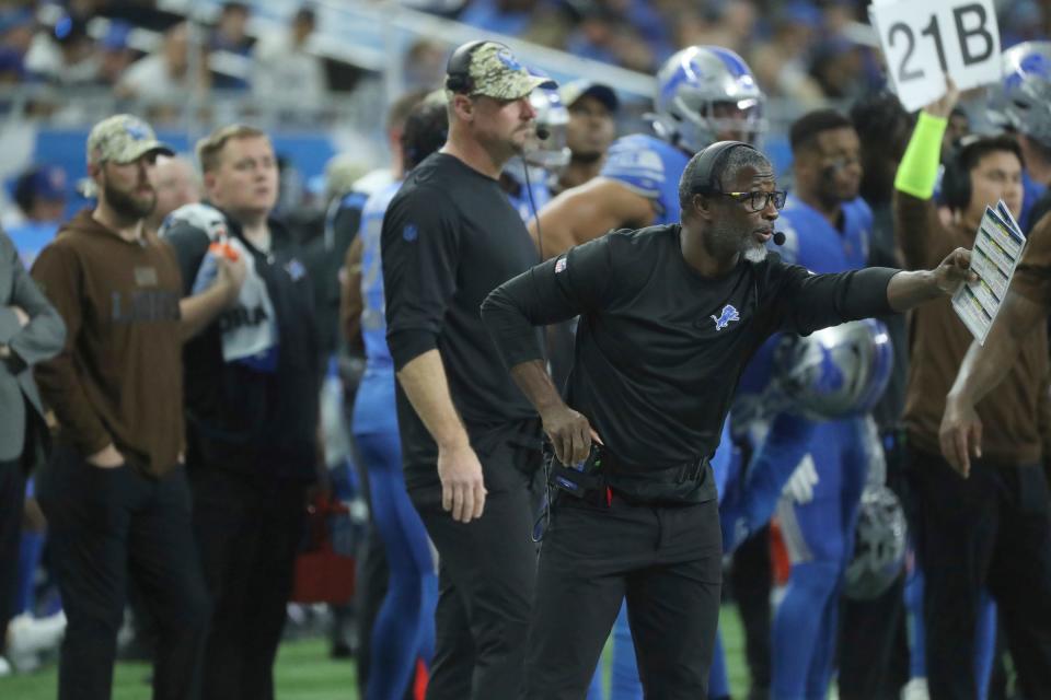 Detroit Lions defensive coordinator Aaron Glen shouts instructions as coach Dan Campbell, background, looks on during action against the Chicago Bears at Ford Field Sunday, Nov. 19, 2023.