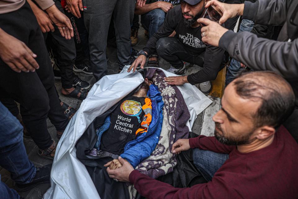 Relatives and friends mourn by the body of Saif Abu Taha, a World Central Kitchen staff member killed along with seven colleagues Monday in an Israeli drone strike.