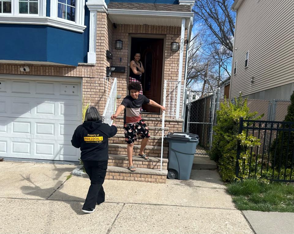 Operation Ceasefire marchers on Saturday, April 6, hand out palms to parade watchers along the route in Paterson.