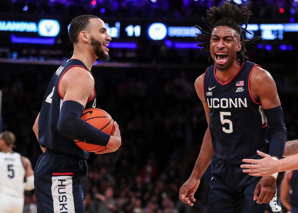 Connecticut Huskies forward Isaiah Whaley (5) celebrates with guard Tyrese Martin (4) after blocking a shot in the first half against the Villanova Wildcats at the Big East Tournament at Madison Square Garden.