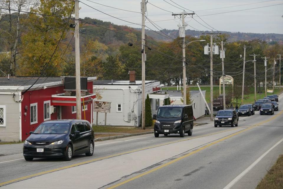 Three vehicles transport the victims killed at Schemengees Bar and Grille, on Thursday, Oct. 26, 2023, in Lewiston, Maine. The restaurant was the site of one of the two mass shootings in Lewiston on Wednesday. (AP Photo/Robert F. Bukaty)