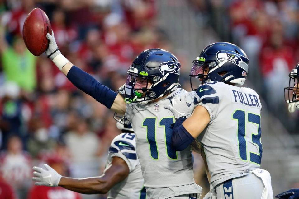 Seattle Seahawks wide receiver Cody Thompson (11) celebrates his fumble recovery on an attempted punt by the Arizona Cardinals with Seahawks’ Aaron Fuller (13) and Seahawks wide receiver Penny Hart, left, during the second half of an NFL football game Sunday, Jan. 9, 2022, in Glendale, Ariz. (AP Photo/Ralph Freso)