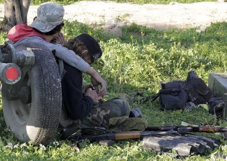 Ansar Al-Sham Brigade fighters rest with their weapons near Jisr al-Shoghour, Idlib province March 25, 2015. REUTERS/Mohamad Bayoush