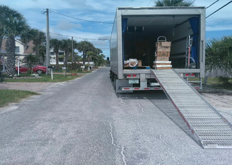 Truck unloads at loading/unloading zone on Cooper Street near Flagler Avenue.