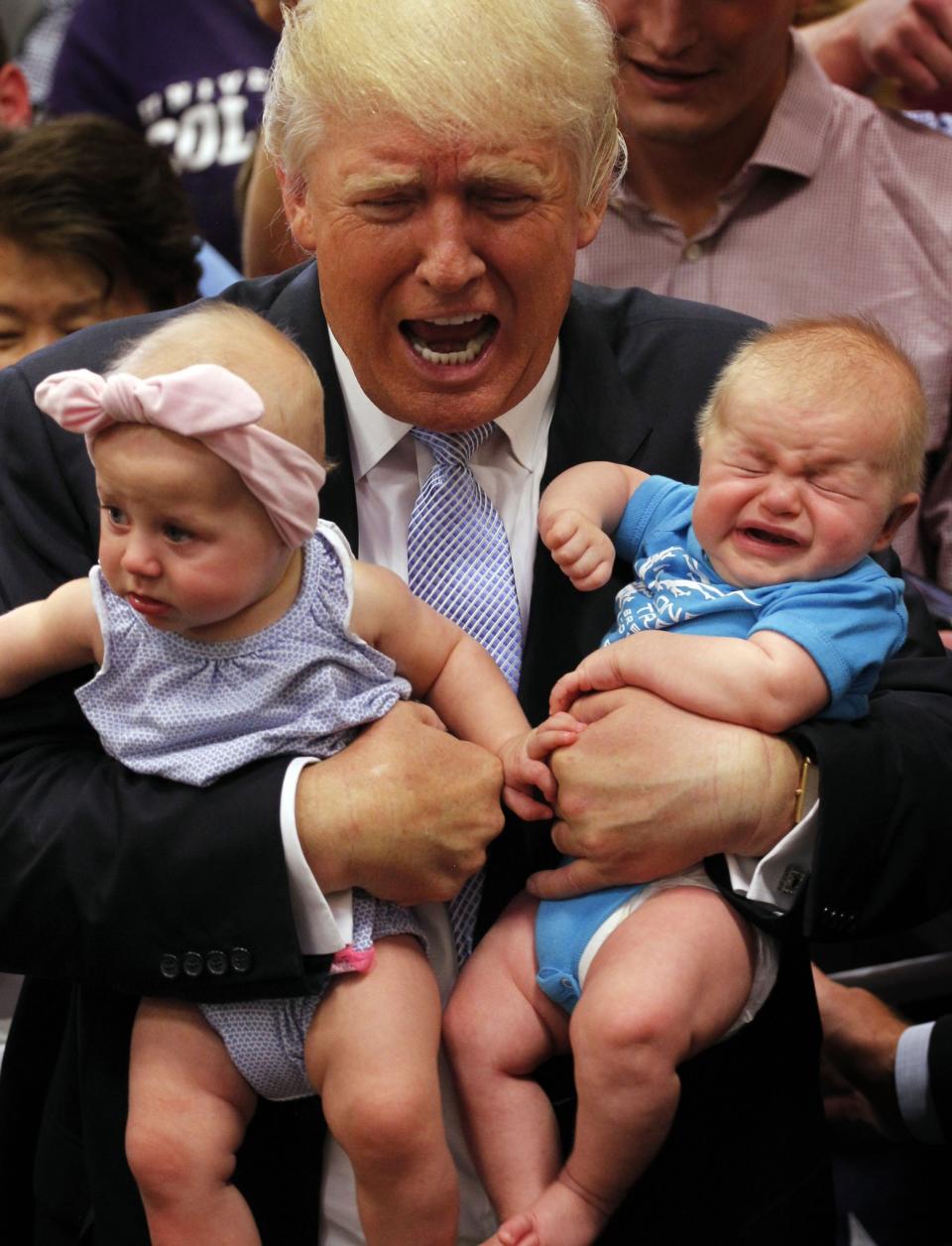 <p>Republican presidential nominee Donald Trump reacts to the cries of three-month-old Kellen Campbell, of Denver, right, while holding six-month-old Evelyn Keane, of Castel Rock, Colo., after Trump’s speech at the Gallogly Event Center on the campus of the University of Colorado on July 29, 2016 in Colorado Springs, Colorado. (Joe Mahoney/Getty Images) </p>