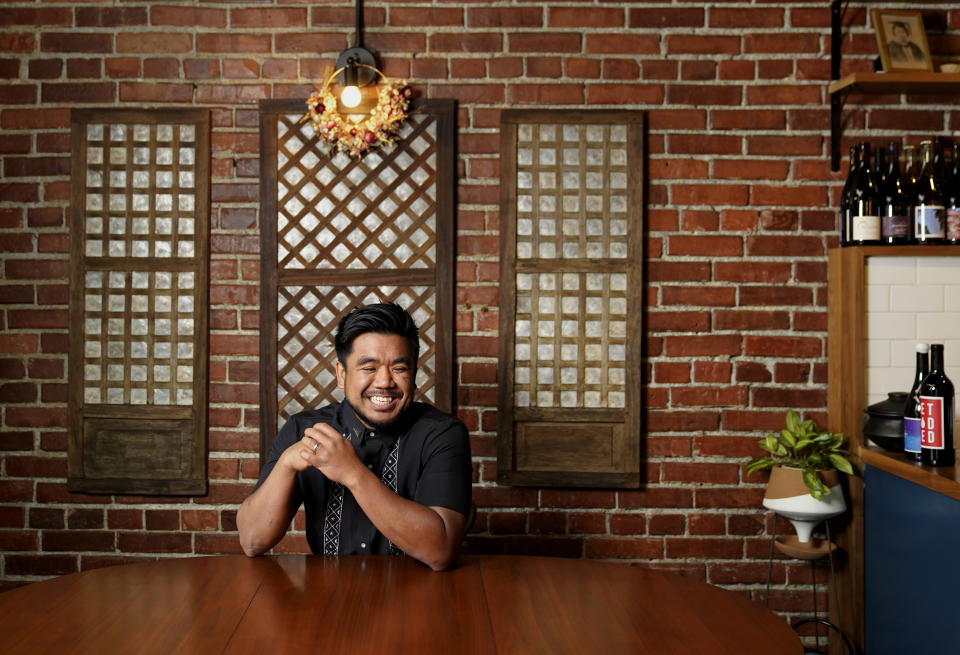 Chef Aaron Verzosa, who is nominated for a 2023 James Beard Award, poses for a portrait in front of capiz windows displayed at his Filipino American restaurant Archipelago Wednesday, May 24, 2023, in Seattle. Verzosa is nominated in the Best Chef: Northwest and Pacific category. (AP Photo/Lindsey Wasson)