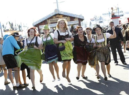 Young women (L-R) Carola, Anne, Tanja, Patrizia, Lena and Lisa from Baden-Wuerttemberg pose while wearing traditional Bavarian dirndls at Munich's 180th Oktoberfest October 3, 2013. REUTERS/Michaela Rehle