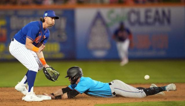 Miami Marlins' Peyton Burdick, bottom, steals second base under