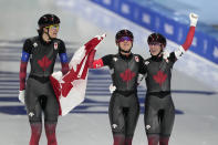 Team Canada's Isabelle Weidemann, left, Valerie Maltais and Ivanie Blondin, right, celebrate after they won the gold medal and set an Olympic record in the speedskating women's team pursuit finals at the 2022 Winter Olympics, Tuesday, Feb. 15, 2022, in Beijing. (AP Photo/Ashley Landis)