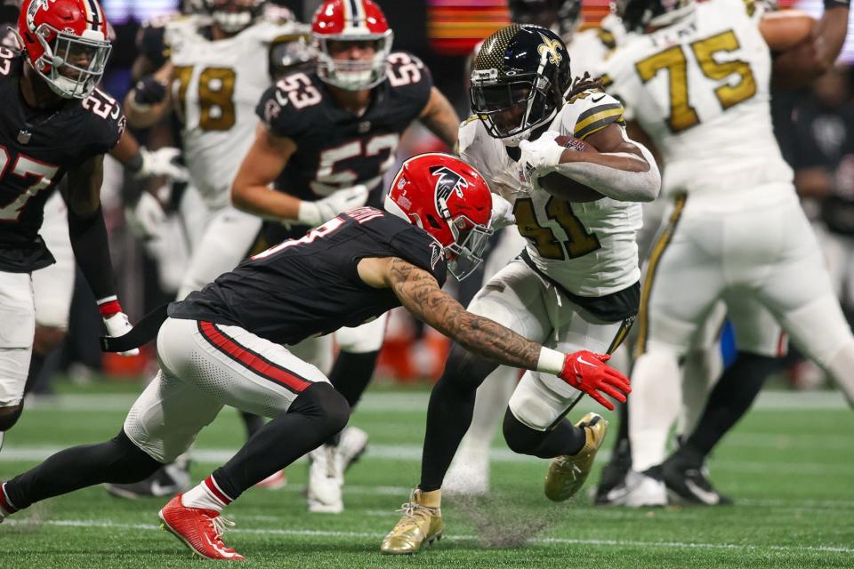 New Orleans Saints running back Alvin Kamara (41) is tackled by Atlanta Falcons safety Jessie Bates III (3) in the second half at Mercedes-Benz Stadium.