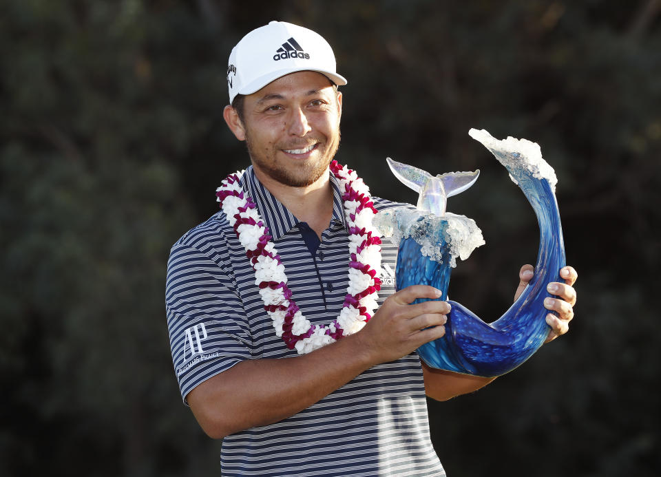 Xander Schauffele holds the champions trophy after the final round of the Tournament of Champions golf event, Sunday, Jan. 6, 2019, at Kapalua Plantation Course in Kapalua, Hawaii. (AP Photo/Matt York)