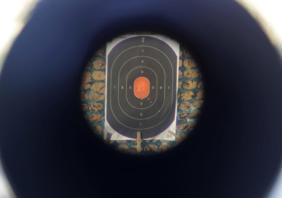 Bullet holes cluster in the center of a target at the Kaukauna Sportsman's Club range.