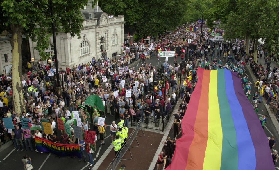 Revellers pass along the Victoria Embankment in central London, as the Gay Pride Mardi Gras 2003 parade begins. The parade passes through central London to Hyde Park where Pride in the Park is set to take place.   