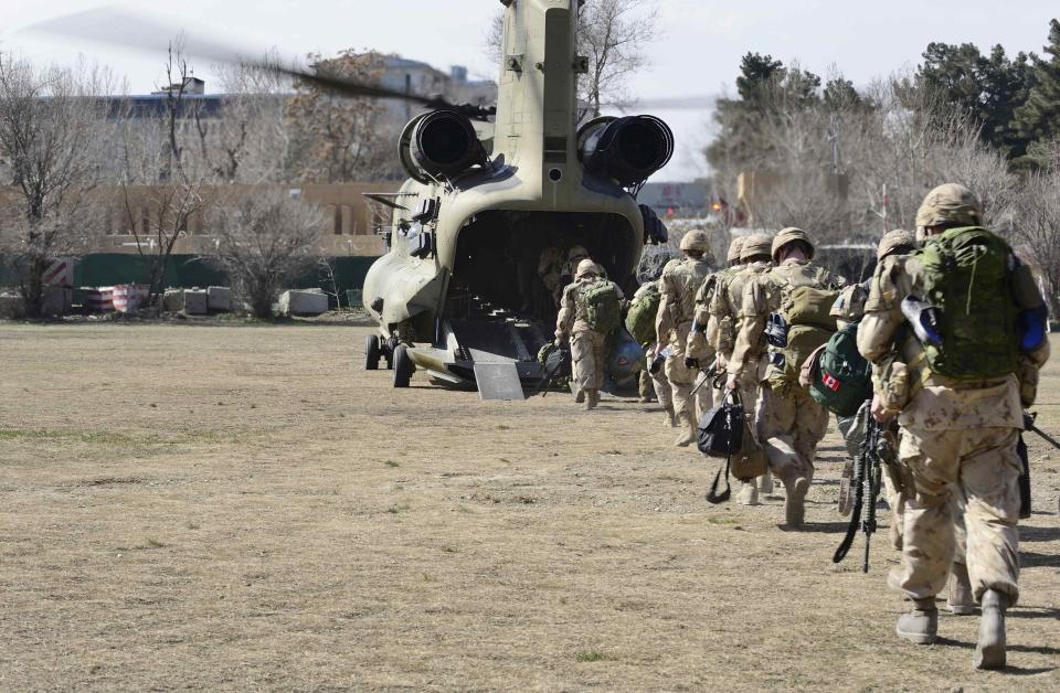 The last Canadians involved in the NATO training mission in Afghanistan board a U.S. Chinook helicopter in Kabul