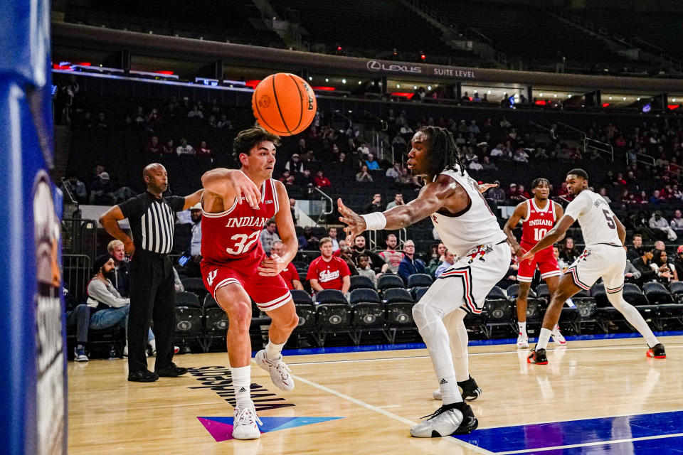 Indiana guard Trey Galloway attempts an inbounds pass against Louisville guard Mike James in an NCAA college basketball game in the Empire Classic tournament in New York, Monday, Nov. 20, 2023. (AP Photo/Peter K. Afriyie)