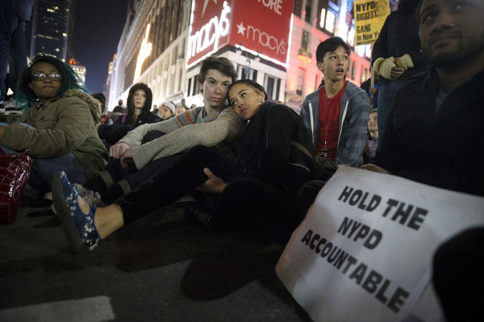 Protestors occupy Herald Square during march Thursday, Dec. 4, 2014, in New York, against a grand jury's decision not to indict the police officer involved in the death of Eric Garner. A grand jury cleared a white New York City police officer Wednesday in the videotaped chokehold death of Garner, an unarmed black man, who had been stopped on suspicion of selling loose, untaxed cigarettes, a lawyer for the victim's family said. (AP Photo/John Minchillo)