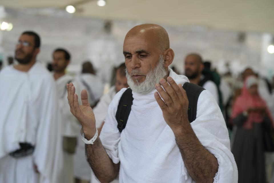 Muslim pilgrims pray during the symbolic stoning of the devil ritual during the Hajj pilgrimage, in Mina near the city of Mecca, Saudi Arabia, Saturday, July 9, 2022. (AP Photo/Amr Nabil)